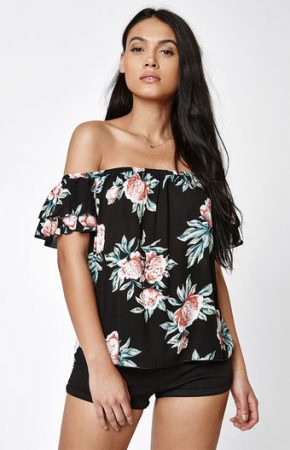 Black off-the-shoulder top with pink and white floral pattern.