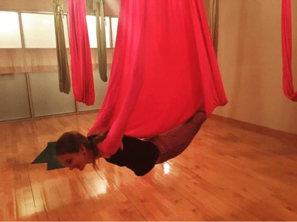 girl doing aerial yoga pose