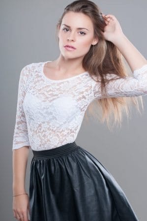 woman in white top and pleated leather skirt