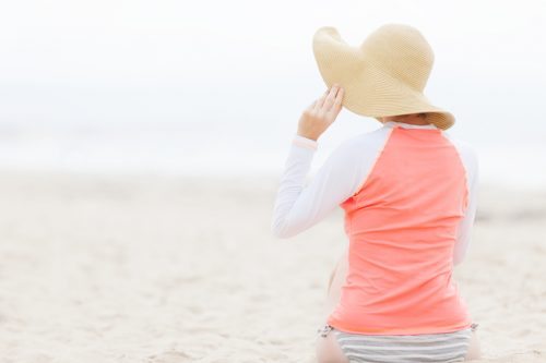 view of woman from behind on beach