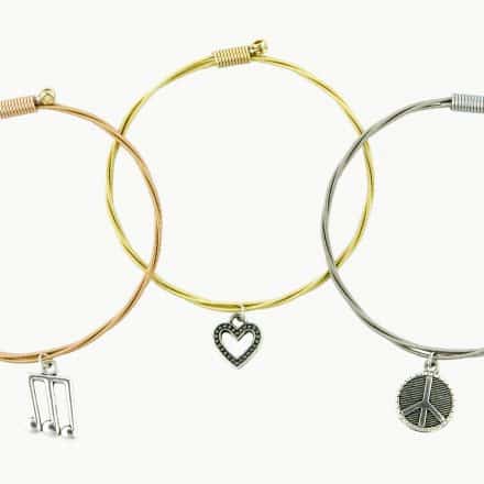 Set of three bracelets with music, heart and peace charms