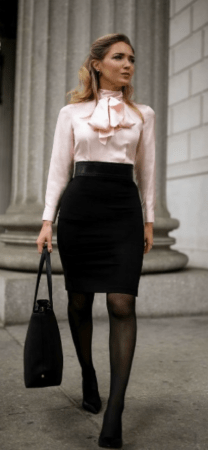 Woman wearing pencil skirt, blouse and carrying a canvas tote