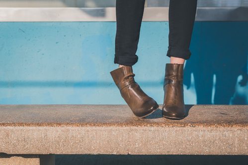 Don't tuck loose jeans into your ankle boots - roll them up instead.