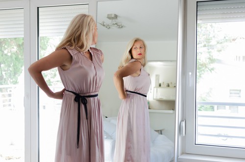 Woman trying on pink dress