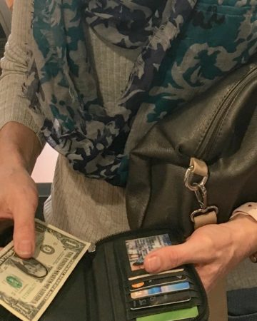 Counting money: me with my open wallet and $1 