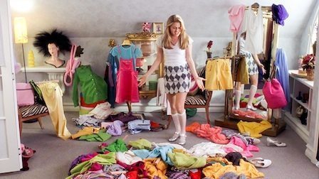 woman surrounded by colorful clothes