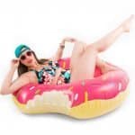 Plus size model poses in a plastic donut