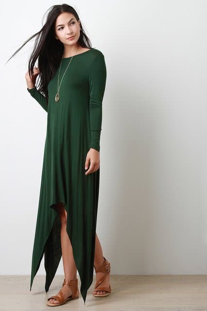 dark haired woman wearing green shark bite dress