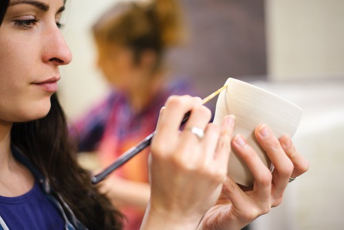 girl painting pottery