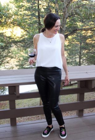 Catherine Brock Budget Fashionista wearing faux leather leggings and white top with sneakers.