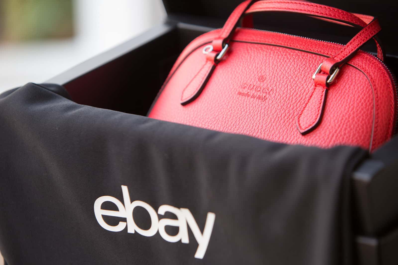 red handbag in an eBay package