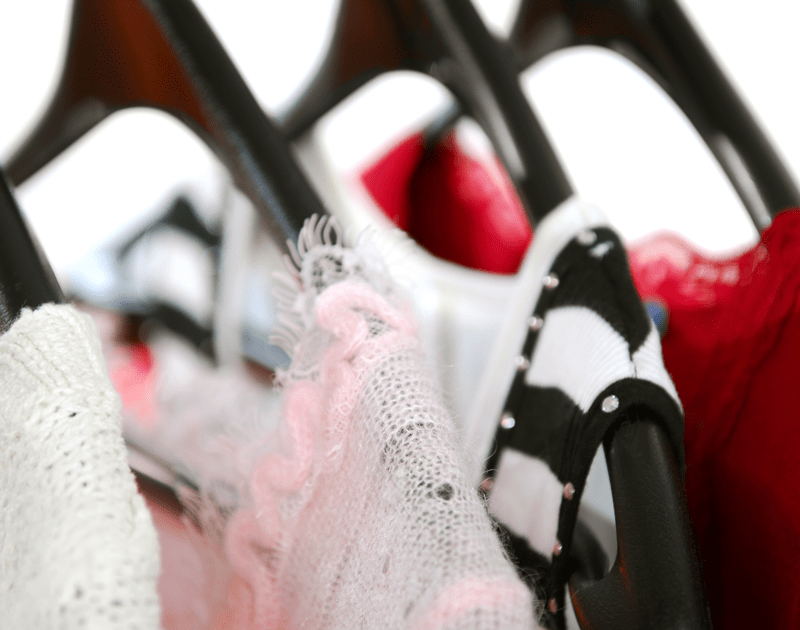 colored shirts on wooden hangers