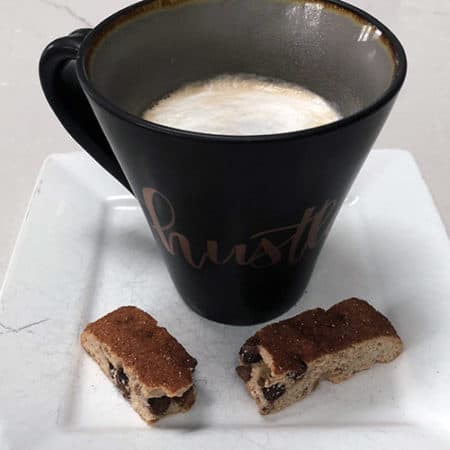 Cup of coffee and soft-baked biscotti on a plate